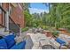 Backyard featuring a stone patio, lounge furniture, fire pit and brick landscape features at 8 Pine Top Pl, Durham, NC 27705