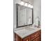 Bathroom featuring a vanity with granite countertop, framed mirror and modern light fixture at 8 Pine Top Pl, Durham, NC 27705