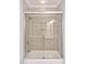 Bathroom featuring a tiled shower and tub with glass doors and modern fixtures at 8 Pine Top Pl, Durham, NC 27705
