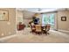 Bonus room features a dining table, arcade game and a window letting in natural light at 8 Pine Top Pl, Durham, NC 27705