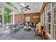 Inviting covered patio featuring brick walls, stylish seating, and a ceiling fan for comfortable outdoor living at 8 Pine Top Pl, Durham, NC 27705