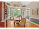 Elegant dining room features a large bay window, wood floors, and a beautiful light fixture at 8 Pine Top Pl, Durham, NC 27705