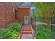 Exterior featuring brick stairs and lush landscaping at 8 Pine Top Pl, Durham, NC 27705