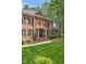 Elegant brick home with black shutters and a manicured lawn creates a classic and inviting curb appeal at 8 Pine Top Pl, Durham, NC 27705