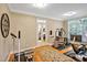 Bright home gym with exercise equipment, hardwood floors, french doors and large windows with shuttered blinds at 8 Pine Top Pl, Durham, NC 27705