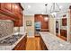 Modern kitchen with granite countertops, stainless steel appliances, and custom cabinetry at 8 Pine Top Pl, Durham, NC 27705