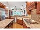 Gourmet kitchen featuring granite countertops, farmhouse sink, and custom cabinets at 8 Pine Top Pl, Durham, NC 27705