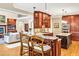 Open kitchen with granite island, stainless appliances, and custom wood cabinets at 8 Pine Top Pl, Durham, NC 27705