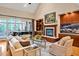 Elegant living room with fireplace, built-ins, large windows and grand piano at 8 Pine Top Pl, Durham, NC 27705