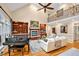 Open-concept living room with a fireplace, built-in shelving, and a grand piano at 8 Pine Top Pl, Durham, NC 27705