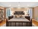 Bedroom featuring hardwood floors, a wooden bed frame, shutters, and matching nightstands for a complete look at 8 Pine Top Pl, Durham, NC 27705