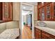 Butlers pantry with custom cabinetry, granite countertop, and hardwood flooring at 8 Pine Top Pl, Durham, NC 27705