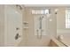 Elegant shower with custom tile work, multiple showerheads, and glass door at 8 Pine Top Pl, Durham, NC 27705