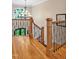 Elegant staircase with wooden banister, iron spindles, and abundant natural light through the arched window at 8 Pine Top Pl, Durham, NC 27705