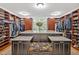 A large walk-in closet with an island, ample built-in shelving, and natural light at 8 Pine Top Pl, Durham, NC 27705