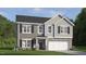 Charming two-story home featuring gray and light-gray siding, a two-car garage, and a covered entryway at 801 Comice Pear Way, Willow Springs, NC 27592
