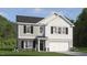 Charming two-story home showcasing a mix of gray siding and brick accents, plus a two-car garage at 812 Comice Pear Way, Willow Springs, NC 27592