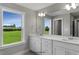 Bathroom featuring dual sinks, bright natural light, and modern finishes at 89 Merle Way, Wendell, NC 27591