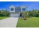 Attractive two-story home with a well-manicured lawn and a two-car garage at 89 Merle Way, Wendell, NC 27591