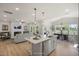 Open floor plan featuring a modern kitchen, living room with fireplace, and dining area with bright, natural light at 89 Merle Way, Wendell, NC 27591