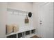 Bright mud room featuring a built-in bench with storage cubbies and a coat rack, creating an organized entryway at 89 Merle Way, Wendell, NC 27591