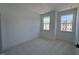 Bright bedroom with carpet floors and two large windows at 1003 Regalia Rd # 33, Durham, NC 27713