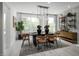 Modern dining room featuring an elegant light fixture, stylish furniture, and a textured accent wall at 1003 Regalia Rd # 33, Durham, NC 27713
