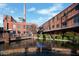 Charming exterior view of historic brick buildings with a water feature in the foreground at 1003 Regalia Rd # 33, Durham, NC 27713