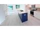 Bright, open kitchen with a blue island and white cabinetry at 1003 Regalia Rd # 33, Durham, NC 27713