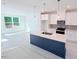 Modern kitchen with white cabinets, an island, and stainless steel appliances at 1003 Regalia Rd # 33, Durham, NC 27713