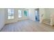 Bright living room with three windows and light wood floors at 1003 Regalia Rd # 33, Durham, NC 27713