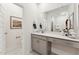 This bathroom has gray cabinets, quartz countertops, a sink, and a large mirror at 101 Ailey Brook Way # 200, Wake Forest, NC 27587