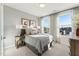 This bedroom has lots of natural light, neutral curtains, and carpet at 101 Ailey Brook Way # 200, Wake Forest, NC 27587