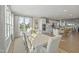 Sunny dining area with modern table, chairs, and view to the kitchen, creating a stylish and functional space at 101 Ailey Brook Way # 200, Wake Forest, NC 27587