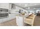Bright kitchen with stainless steel appliances, white cabinets, quartz countertops, and eat-in island at 101 Ailey Brook Way # 200, Wake Forest, NC 27587
