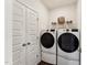 The laundry room has a washer, dryer, and overhead shelving at 101 Ailey Brook Way # 200, Wake Forest, NC 27587