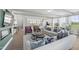 Open-concept living space with abundant natural light, stylish furnishings, and a view into the kitchen at 101 Ailey Brook Way # 200, Wake Forest, NC 27587