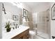 Modern bathroom featuring a vanity with dark hardware, a toilet, and a glass-enclosed shower at 1020 Dillon Lake Dr, Knightdale, NC 27545