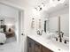 Bathroom featuring double sinks, dark fixtures, and a view into the bedroom at 1020 Dillon Lake Dr, Knightdale, NC 27545