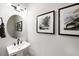 Modern powder room with a pedestal sink, stylish light fixture, and elegant wall art at 1020 Dillon Lake Dr, Knightdale, NC 27545