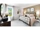 Inviting bedroom with neutral tones, a metal bed frame, and an abundance of natural light at 1020 Dillon Lake Dr, Knightdale, NC 27545