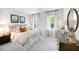 Beautifully staged bedroom with neutral tones, two windows with natural light, and decorative accents at 1020 Dillon Lake Dr, Knightdale, NC 27545