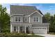Charming two-story home featuring a covered porch, gray siding, and a two-car garage at 1020 Dillon Lake Dr, Knightdale, NC 27545