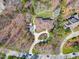 Aerial view showcasing the well-manicured grounds and mature trees surrounding the property at 10210 Governors Drive Dr, Chapel Hill, NC 27517