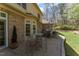 Relaxing patio features a table and chairs for outdoor dining in a verdant backyard at 10210 Governors Drive Dr, Chapel Hill, NC 27517