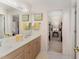 Bright bathroom featuring a double vanity and a view into another bedroom at 10210 Governors Drive Dr, Chapel Hill, NC 27517