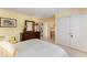 Bedroom with a view of the ensuite bath, featuring a wood dresser and bright yellow walls at 10210 Governors Drive Dr, Chapel Hill, NC 27517