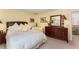 Comfortable bedroom featuring a wood dresser and a plush bed with yellow and white bedding at 10210 Governors Drive Dr, Chapel Hill, NC 27517