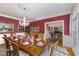 Elegant dining room with set table, chandelier, and open access to other rooms at 10210 Governors Drive Dr, Chapel Hill, NC 27517