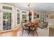 Bright dining area with large windows, hardwood floors, and a charming chandelier at 10210 Governors Drive Dr, Chapel Hill, NC 27517